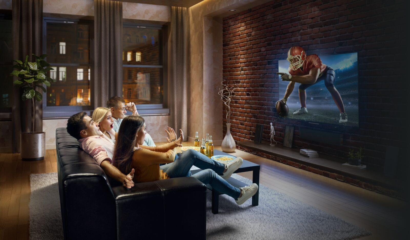 group of people on couch watching tv with football player